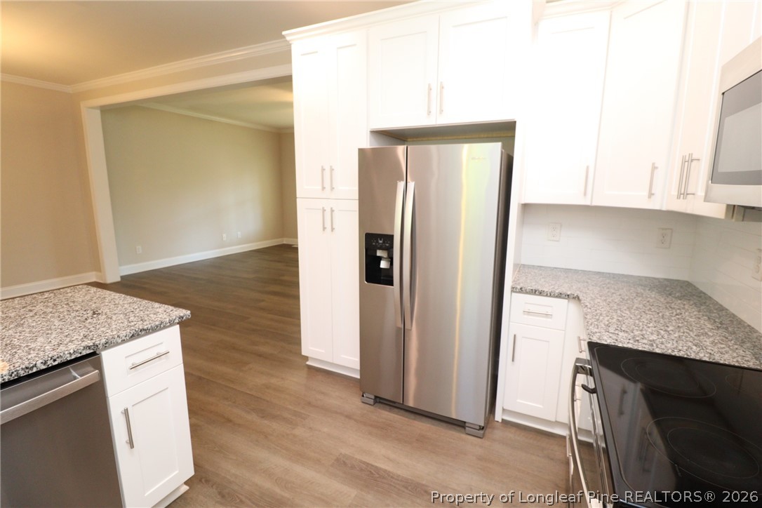 8424 Rhodes Road Apex, NC 27539 - Photo 14 of 31 a kitchen with stainless steel appliances granite countertop a refrigerator and a sink
