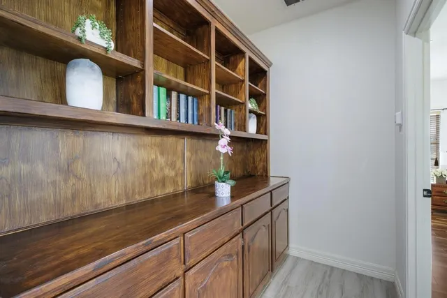 a spacious bedroom with a bed and glass door