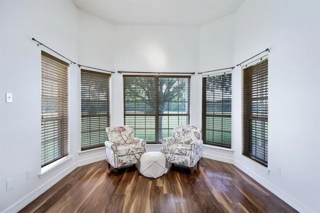 a bathroom with a tub a double vanity sink a window and a mirror