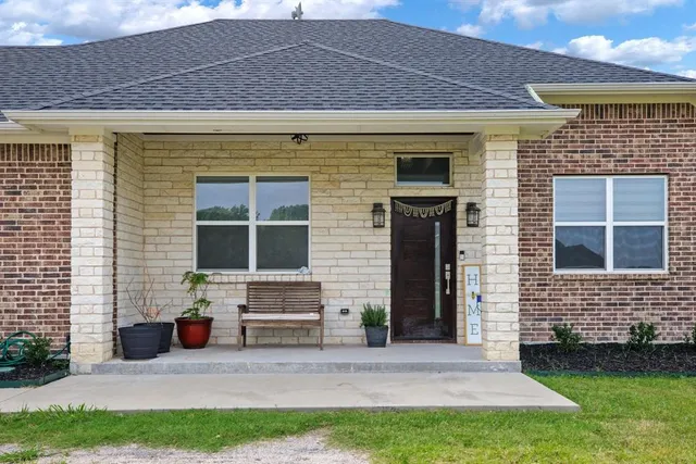 a bedroom with a bed lamp and window