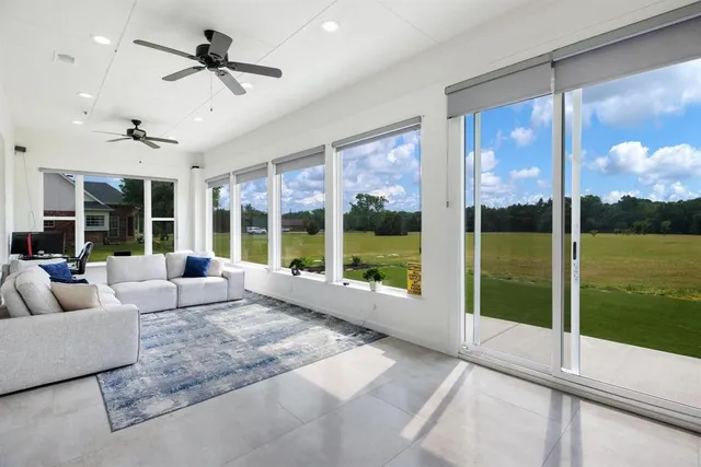 a roof deck with a table and chairs next to a yard