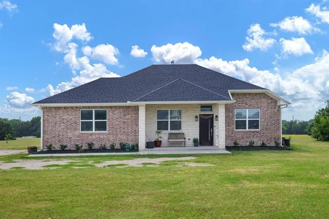 a front view of house with yard and outdoor seating