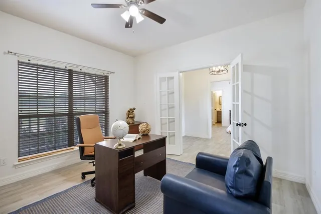 a living room with furniture fireplace and a large window