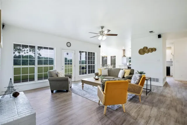 a living room with furniture and kitchen view