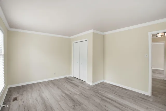a kitchen with kitchen island a wooden floor and stainless steel appliances