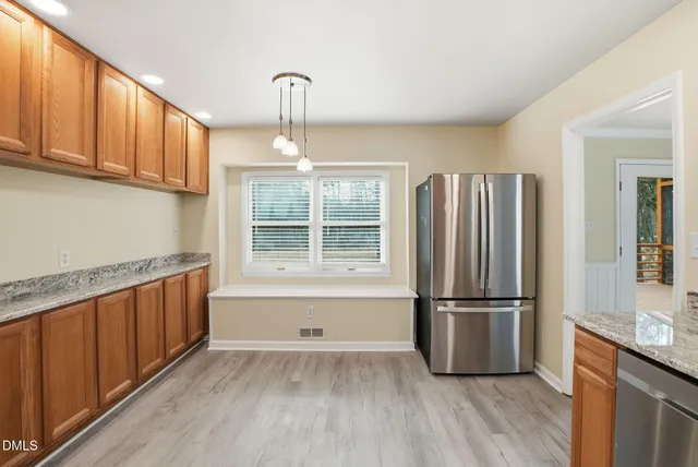 a living room with furniture a fireplace and a large window