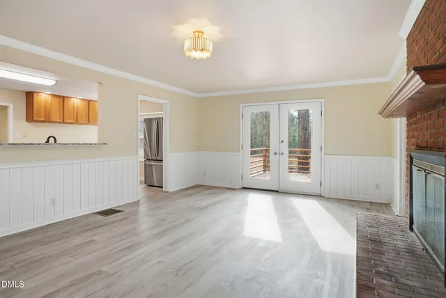 a view of an empty room with wooden floor