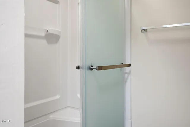 a bathroom with a shower sink vanity and toilet