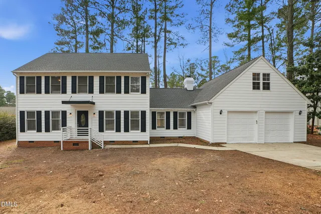 a view of a house with a backyard