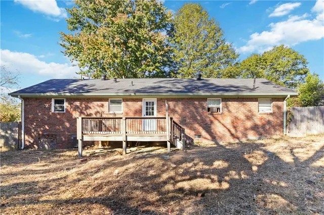 a backyard of a house with table and chairs