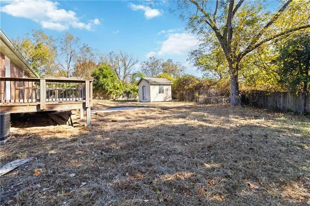 a view of a house with a yard covered in snow