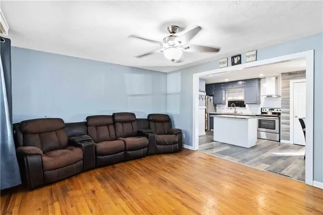 a living room with furniture and kitchen view