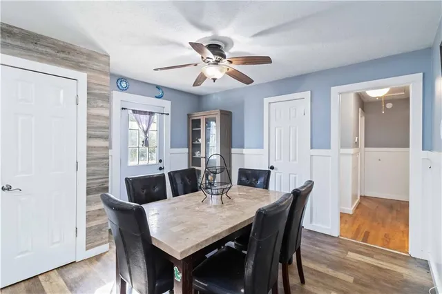 a view of a dining room with furniture and wooden floor