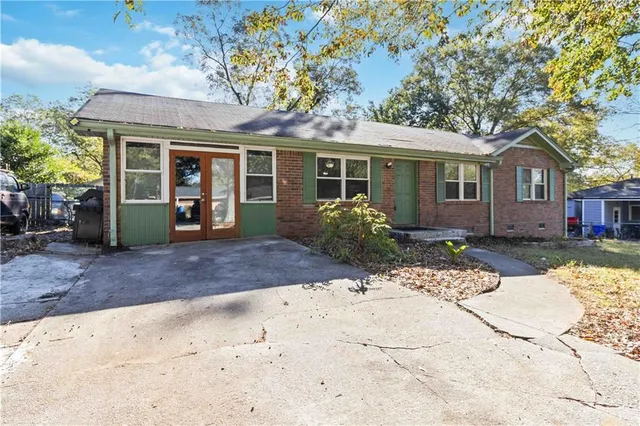 a front view of a house with a garden