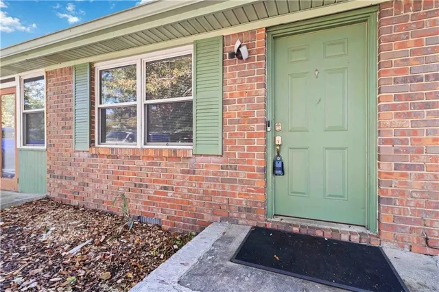 a view of a door of a house with a large window