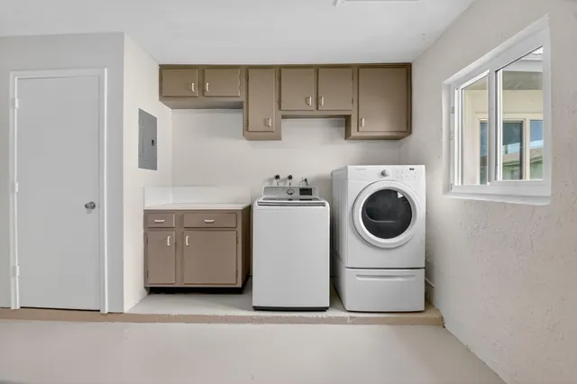a utility room with sink dryer and washer