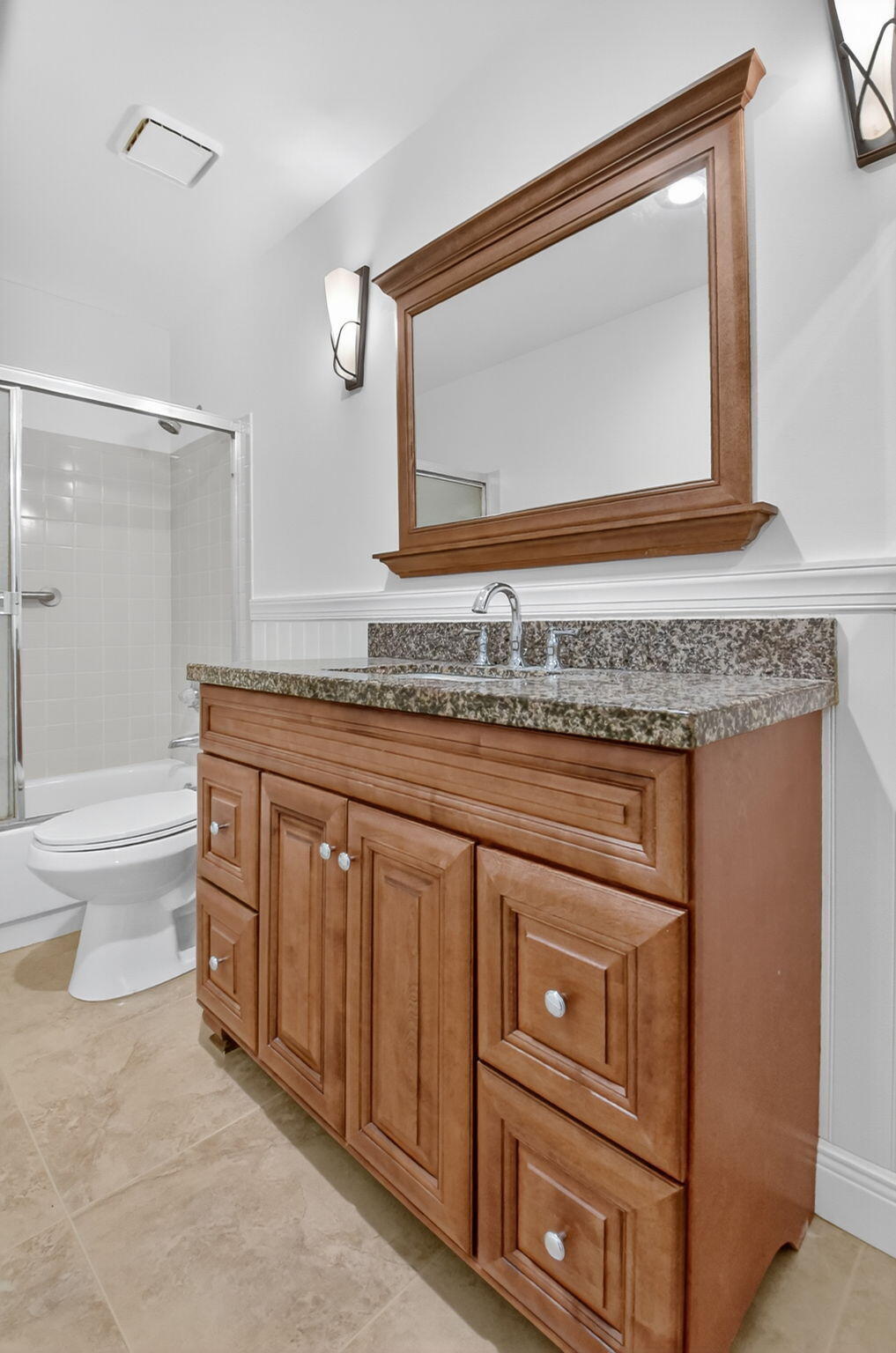 6096 Dusenburg Road Delray Beach, FL 33484 - Photo 17 of 28 a bathroom with a granite countertop toilet sink and mirror