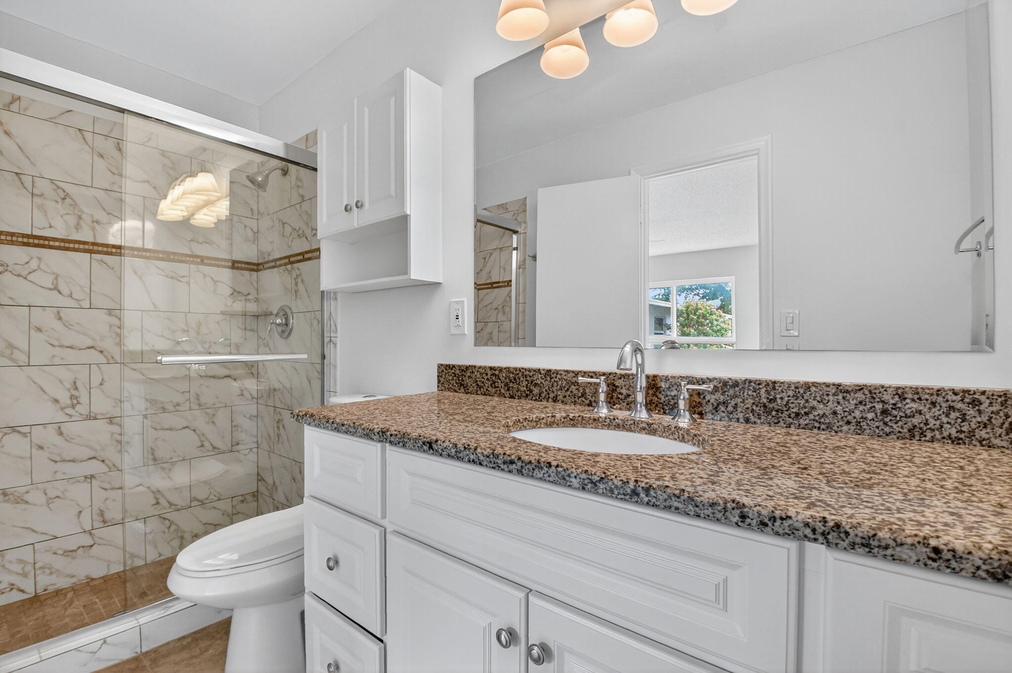 6096 Dusenburg Road Delray Beach, FL 33484 - Photo 21 of 28 a bathroom with a granite countertop toilet sink and mirror