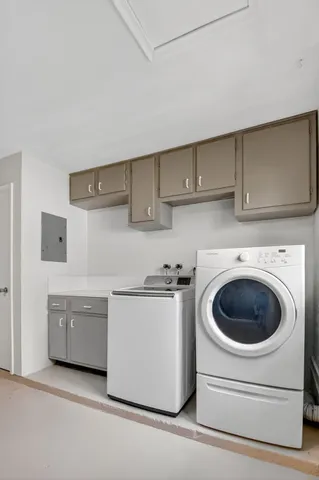 a utility room with sink dryer and washer