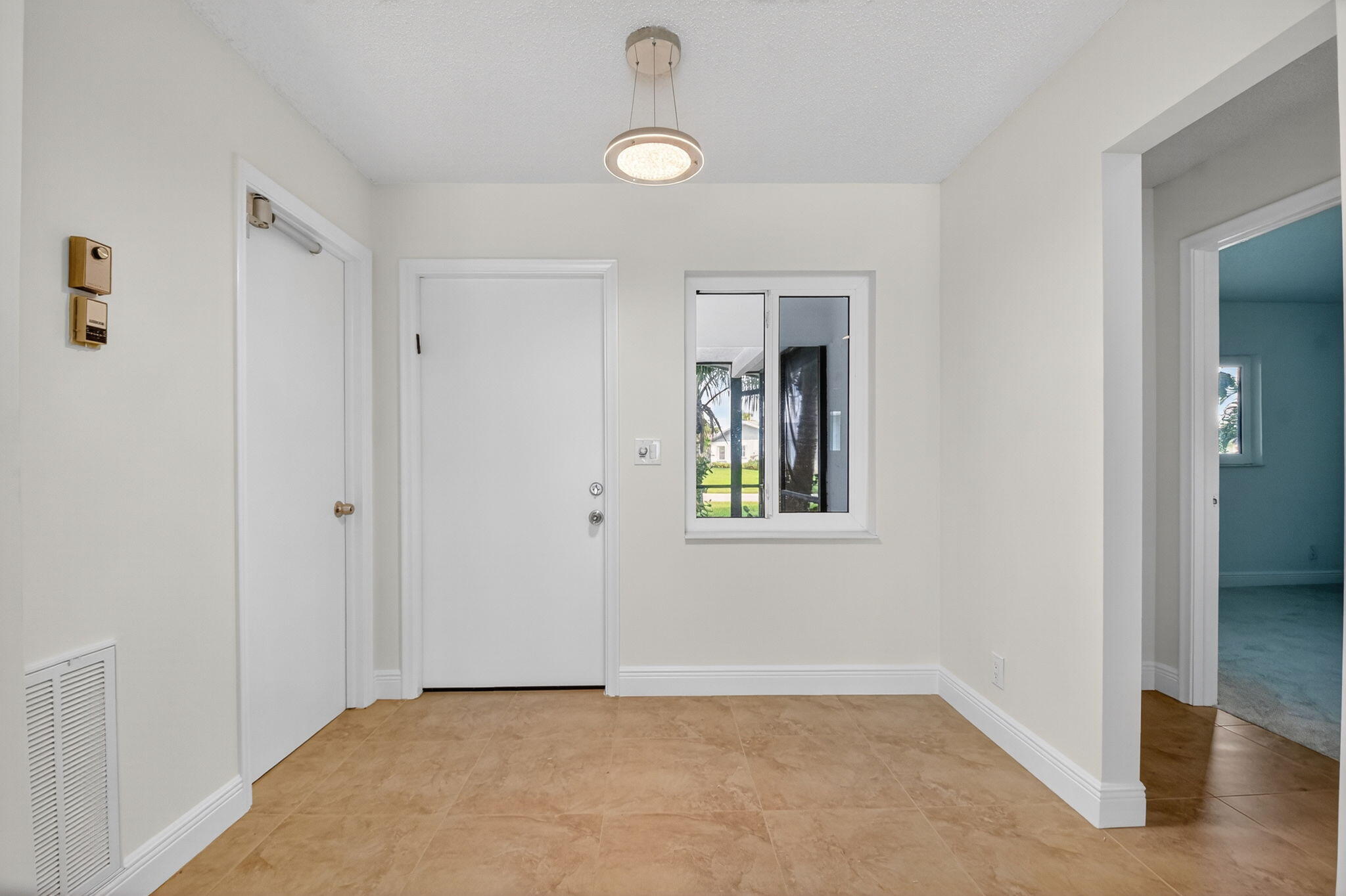 6096 Dusenburg Road Delray Beach, FL 33484 - Photo 3 of 28 a view of an empty room with window and closet area
