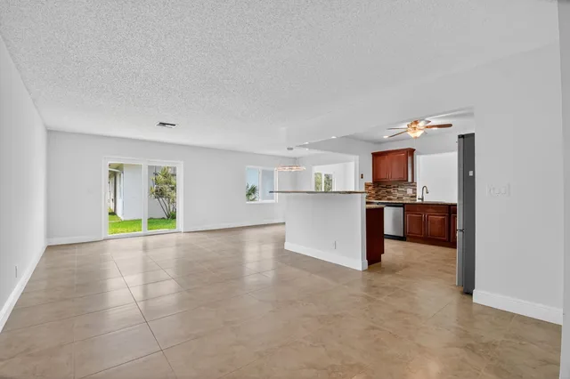 a view of a kitchen with a sink and cabinets