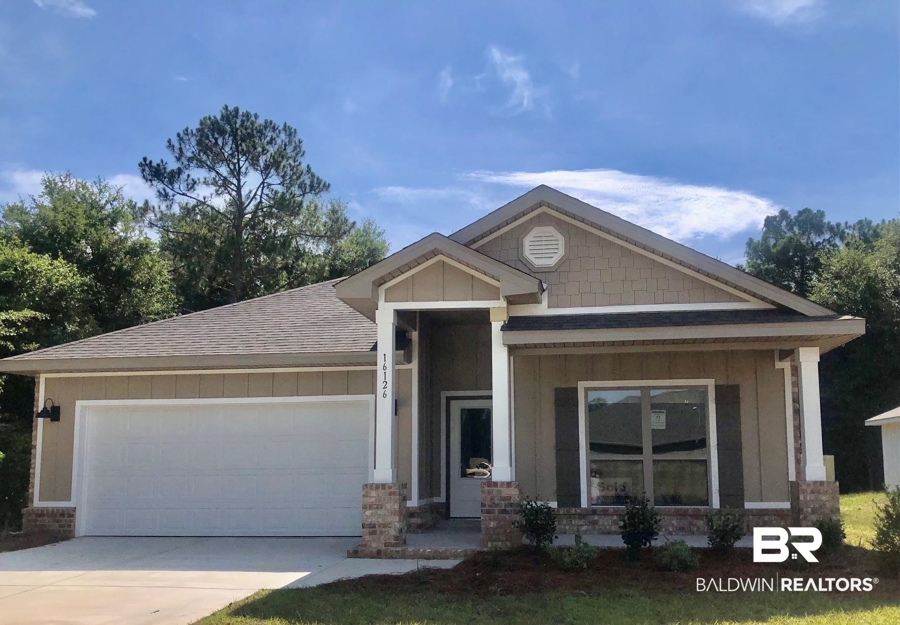 16126 Laurelbrooke Loop Fairhope, AL 36532 - Photo 1 of 46 View of front facade with roof with shingles, driveway, a garage, board and batten siding, and brick siding