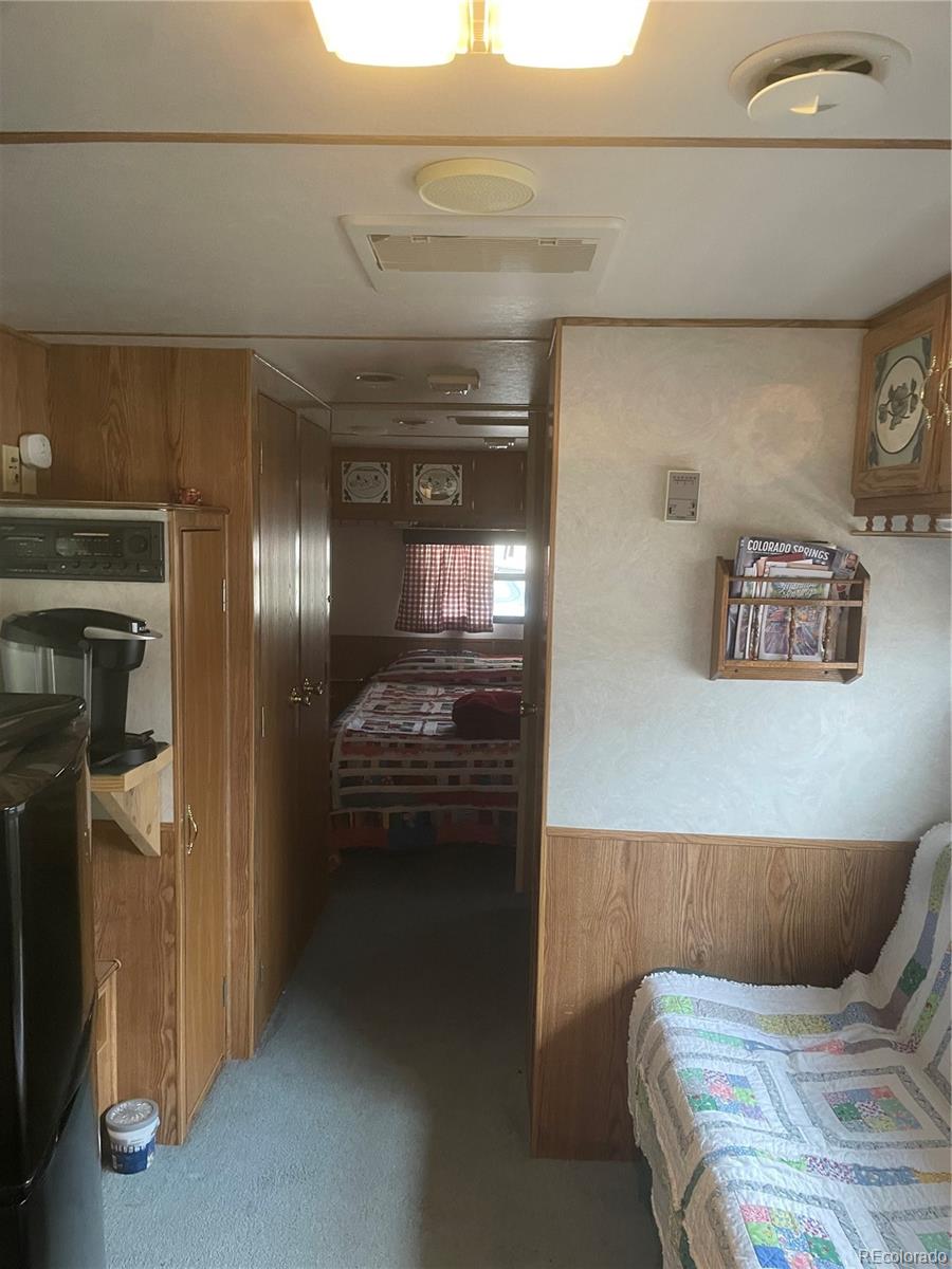 124 Clubcar Road Fairplay, CO 80440 - Photo 7 of 12 a bedroom with a bed and a refrigerator
