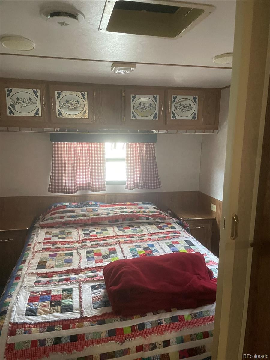 124 Clubcar Road Fairplay, CO 80440 - Photo 9 of 12 a bedroom with a bed and a window