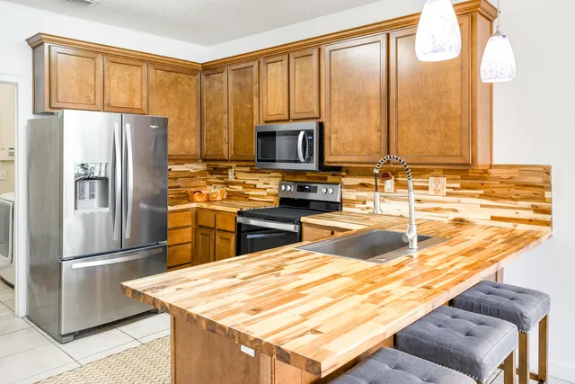 a view of a dining room with furniture and a potted plant
