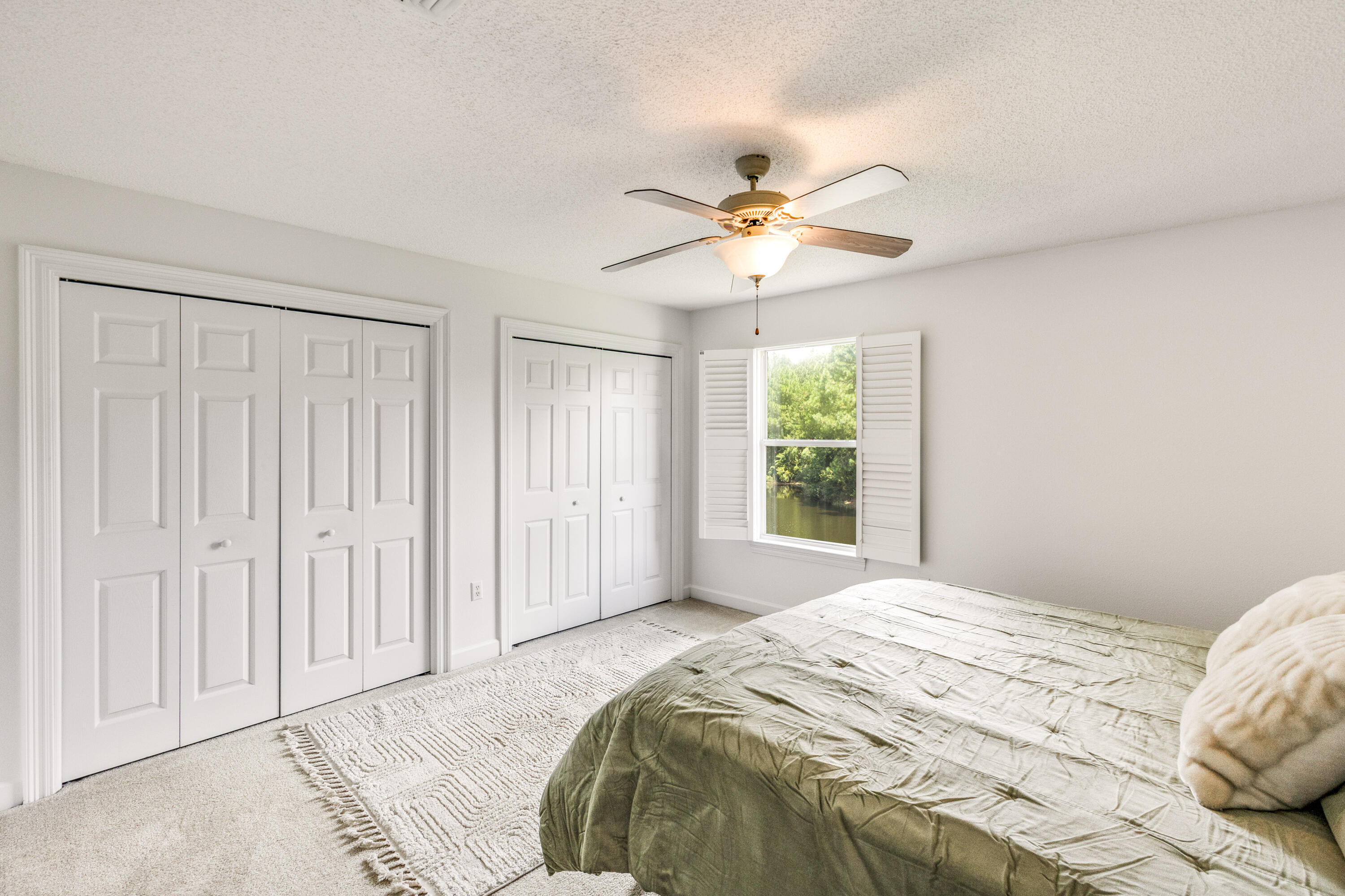 12 Corte Lago Santa Rosa Beach, FL 32459 - Photo 24 of 59 a bedroom with a large bed a chandelier and a window