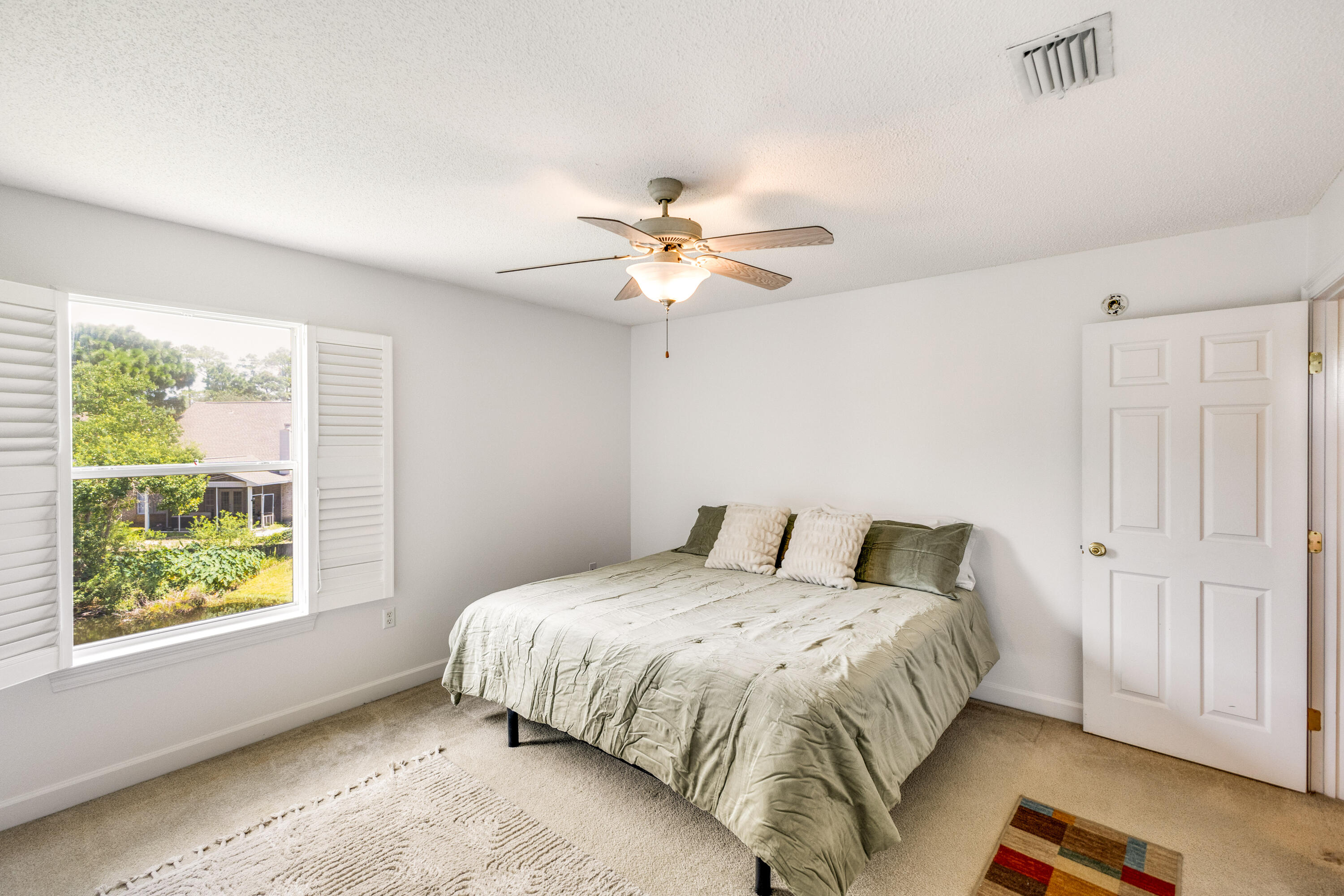12 Corte Lago Santa Rosa Beach, FL 32459 - Photo 25 of 59 a bedroom with a large bed and a chandelier