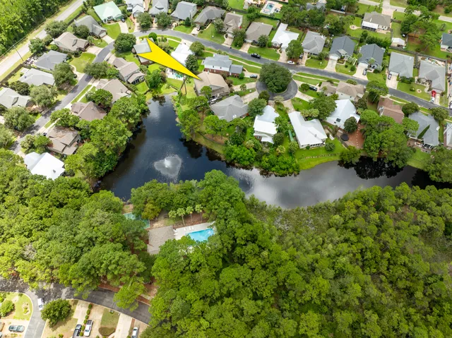 a front view of a house with a yard and potted plants