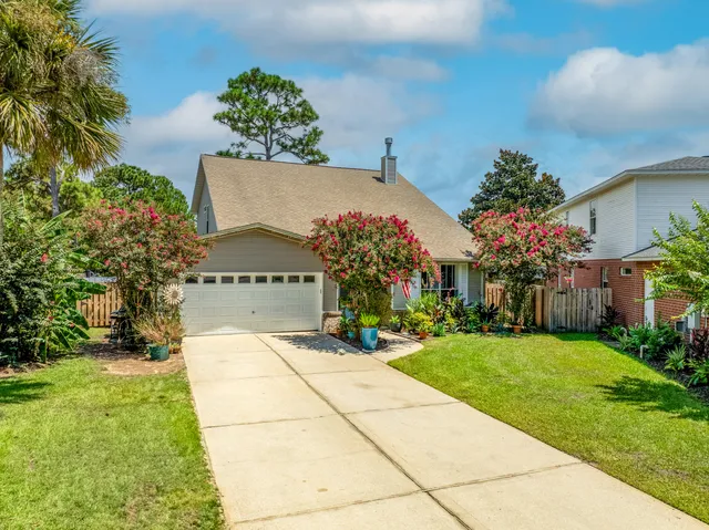 a view of a house with swimming pool and a yard