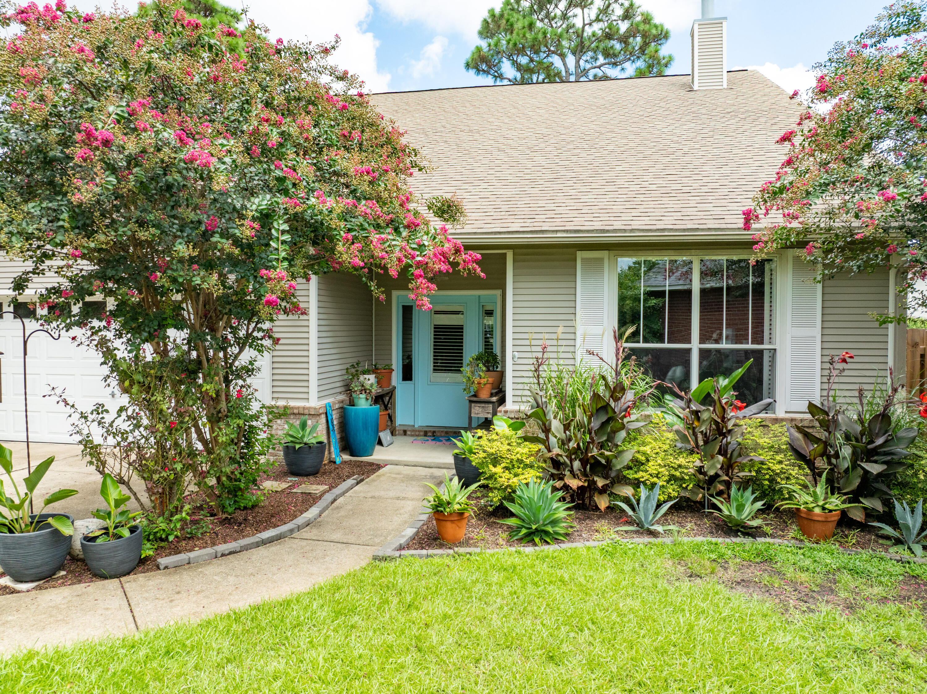 12 Corte Lago Santa Rosa Beach, FL 32459 - Photo 4 of 59 a front view of a house with a yard and potted plants