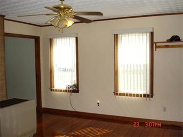 161 Mott Street Fall River, MA 02721 - Photo 7 of 24 a view of an empty room with a window and wooden floor