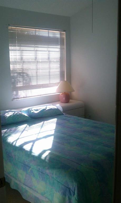 9395 Boca River Circle Boca Raton, FL 33434 - Photo 14 of 18 a view of empty room with wooden floor and fan