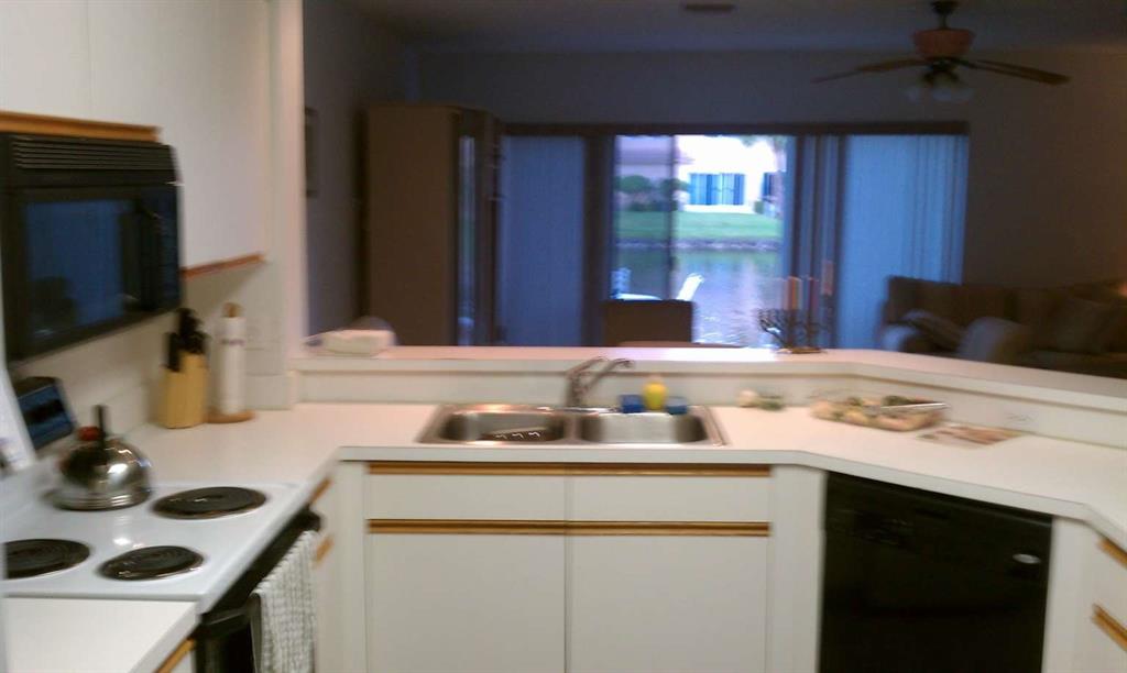 9395 Boca River Circle Boca Raton, FL 33434 - Photo 6 of 18 a kitchen with a sink stove and cabinets