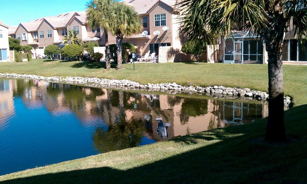 9395 Boca River Circle Boca Raton, FL 33434 - Photo 9 of 18 a view of a house with a yard from a lake view