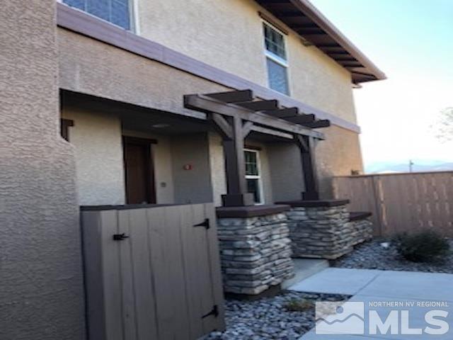 1775 Wind Ranch Road, Unit B Reno, NV 89521 - Photo 1 of 27 a view of a house with a wooden fence