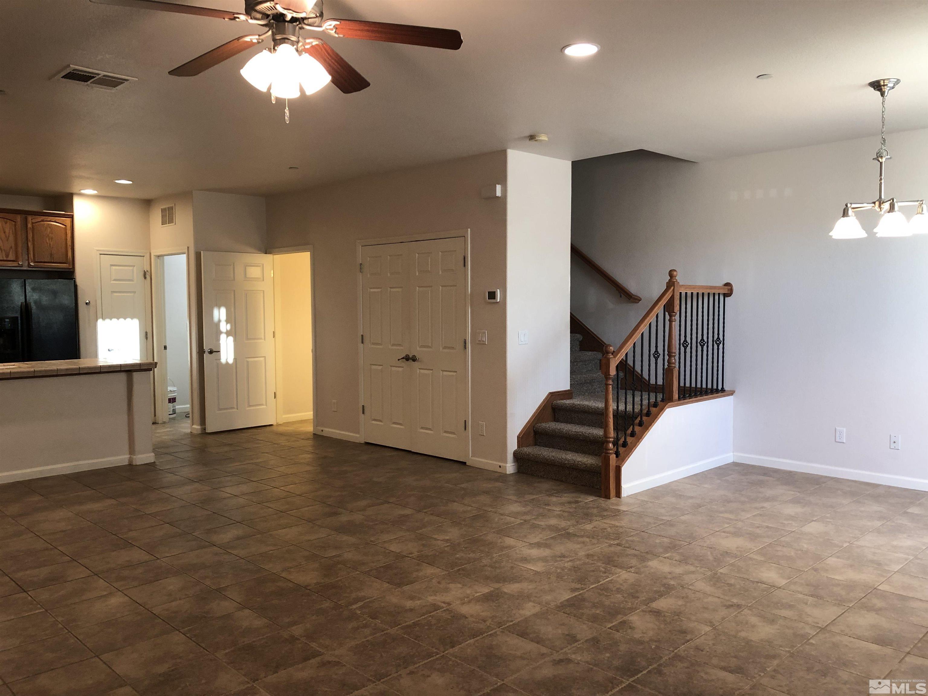 1775 Wind Ranch Road, Unit B Reno, NV 89521 - Photo 11 of 27 a view of an empty room with a chandelier fan