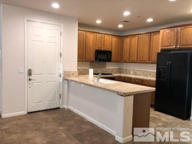 1775 Wind Ranch Road, Unit B Reno, NV 89521 - Photo 12 of 27 a kitchen with a refrigerator and a stove top oven
