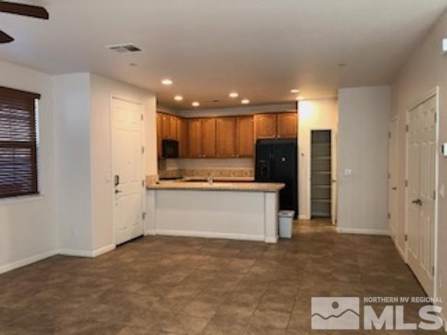 1775 Wind Ranch Road, Unit B Reno, NV 89521 - Photo 17 of 27 a view of kitchen with kitchen island sink refrigerator and white cabinets