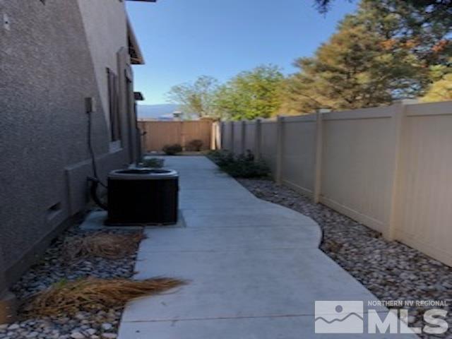1775 Wind Ranch Road, Unit B Reno, NV 89521 - Photo 27 of 27 a view of a backyard with potted plants and wooden fence