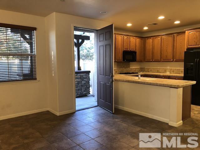 1775 Wind Ranch Road, Unit B Reno, NV 89521 - Photo 3 of 27 a view of a kitchen with a sink and dishwasher