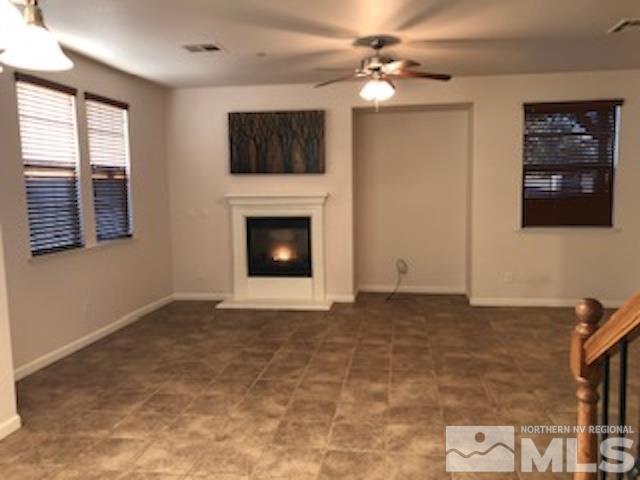 1775 Wind Ranch Road, Unit B Reno, NV 89521 - Photo 7 of 27 a view of an empty room with window and fireplace