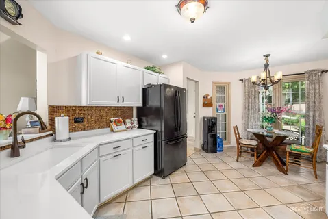 a kitchen with a refrigerator and a sink