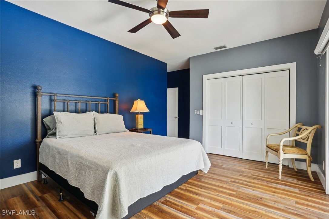 8335 Main Street Bokeelia, FL 33922 - Photo 37 of 47 a bedroom with a bed and a chandelier