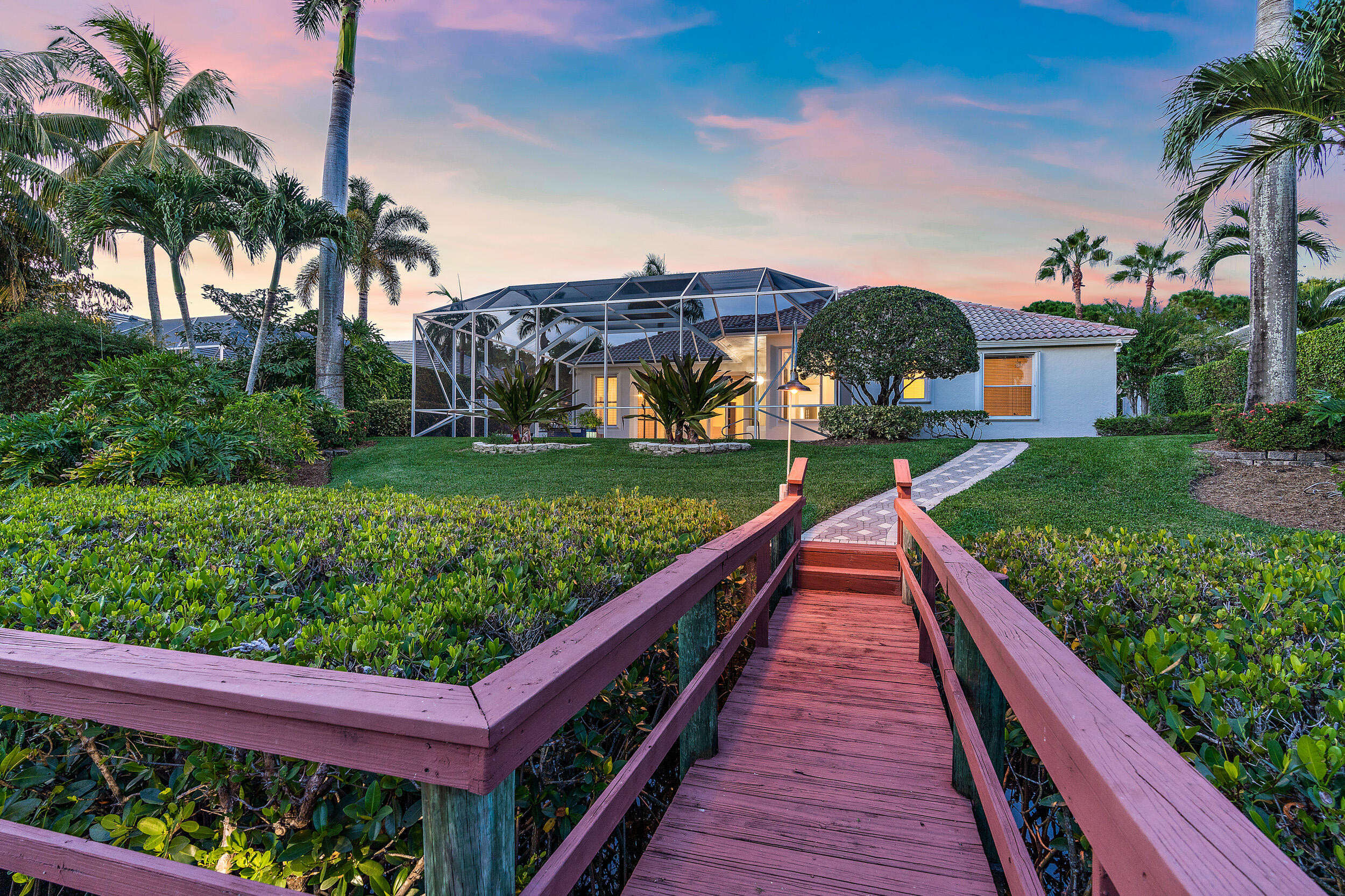 19866 Loxahatchee Pointe Drive Jupiter, FL 33458 - Photo 16 of 43 a view of a house with a yard and potted plants