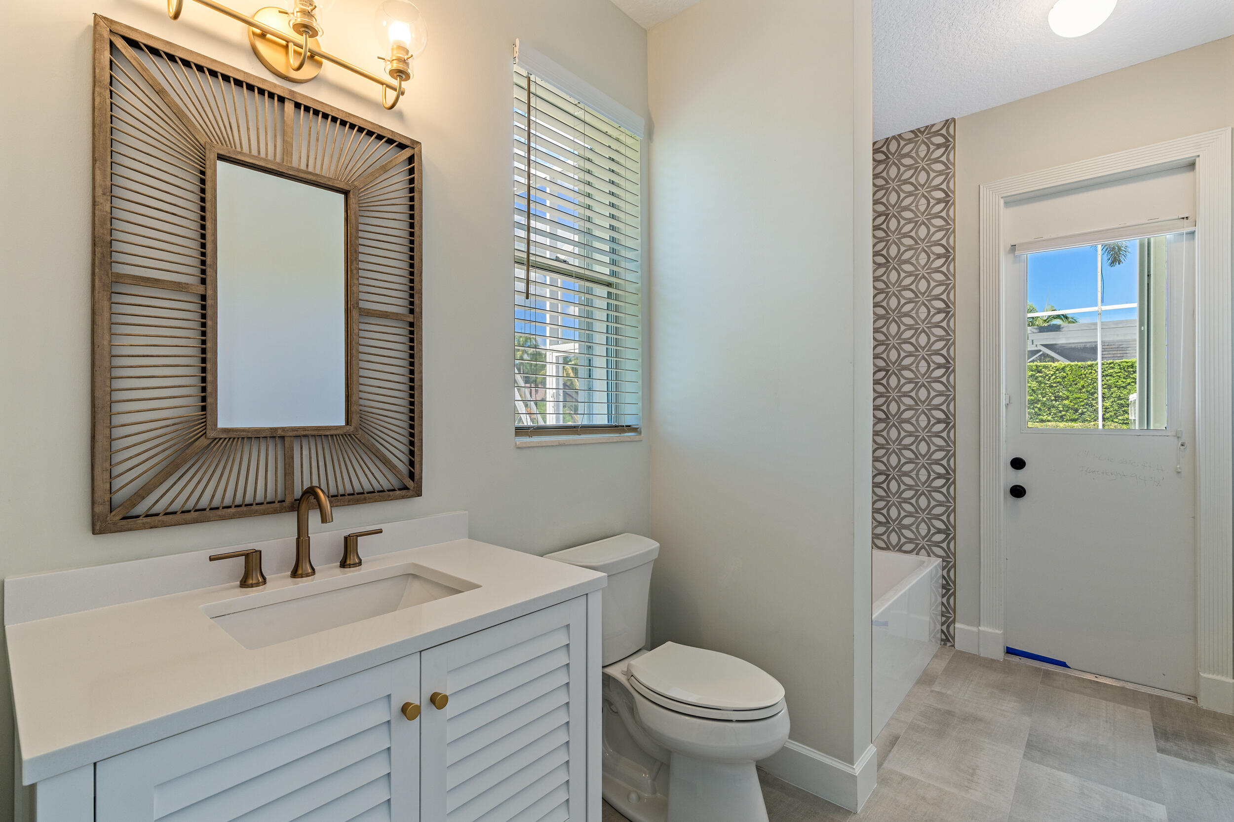 19866 Loxahatchee Pointe Drive Jupiter, FL 33458 - Photo 25 of 43 a bathroom with a sink and a mirror