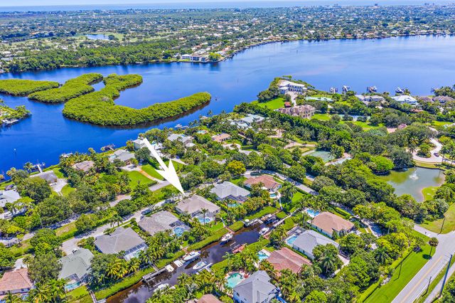 a front view of a house with a garden and trees